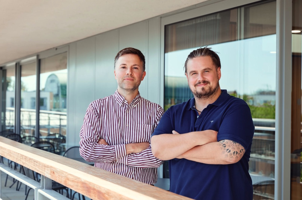 Ben Marshall and Sam Robson, co-founders of Areteon Ventures, standing together on an office balcony
